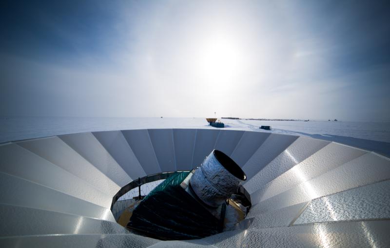 A telescope pokes out from a metal dish.