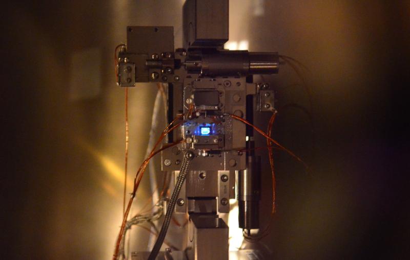 Image - A superthin diamond glows blue during a beam-sharing experiment at SLAC's Linac Coherent Light Source X-ray laser. (Credit: Diling Zhu, SLAC)