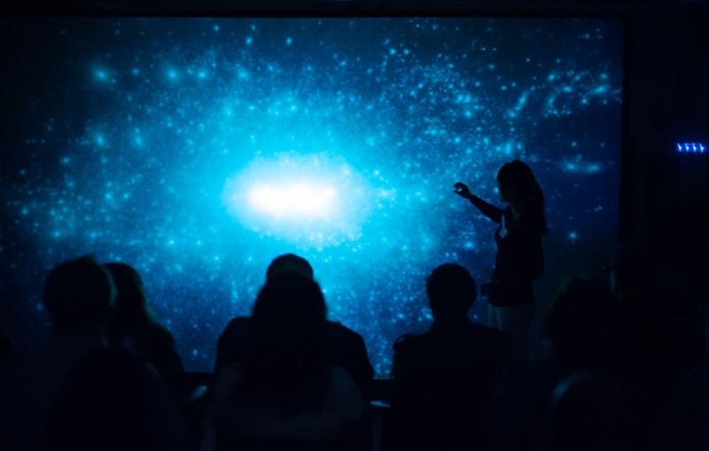 Photo - Student's silhouette against a projection screen.