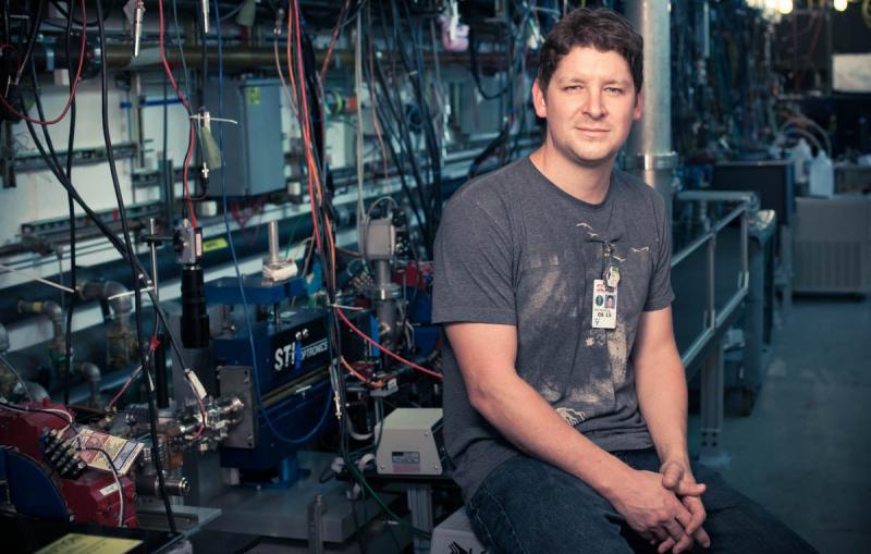 Accelerator physicist Erik Hemsing next to the NLCTA,...