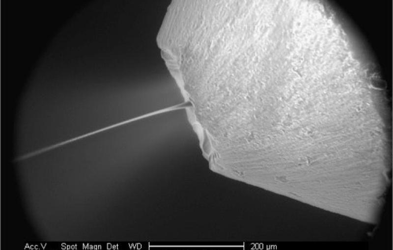 Magnified image of a micro-jet nozzle squirting an oily solution called a "lipidic sponge phase"