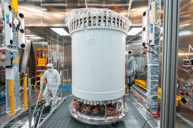 A tall white cylinder stands in a clean room space.