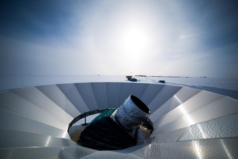 A telescope pokes out from a metal dish.