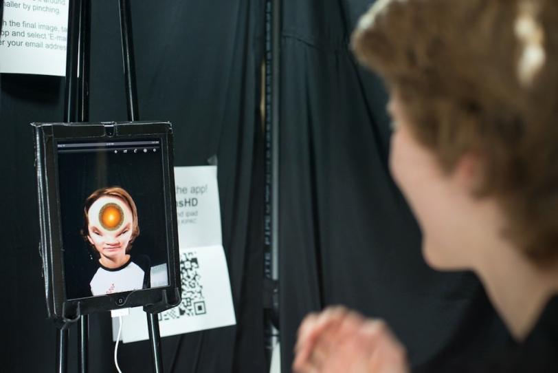 Photo - Boy's reflection in mirror with red sphere on forehead.