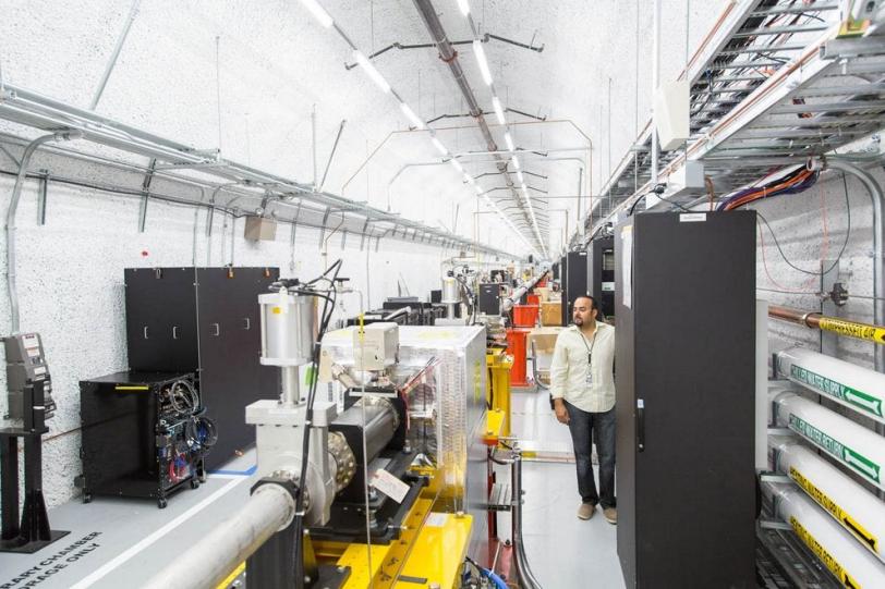 Photo - SLAC's Ruben Curiel views the mirror setup used to switch X-ray pulses between separate instruments at the Linac Coherent Light Source X-ray laser. (Matt Beardsley/SLAC)