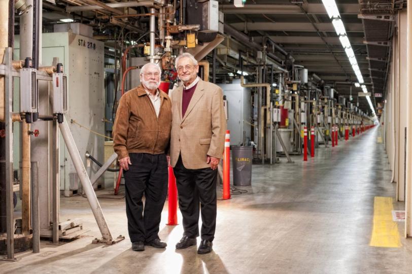 Image - SLAC scientist Herman Winick (left) and visiting scientist Claudio Pellegrini, in the accelerator klystron gallery in 2012. Winick and Pelligrini were instrumental in making the idea of the LCLS a reality. (Matt Beardsley)