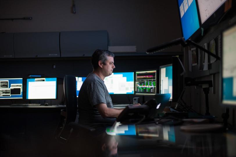 Photo - Sebastian Carron Montero,  engineering physicist for the AMO instrument at LCLS, at work in the AMO control room. (Matt Beardsley)