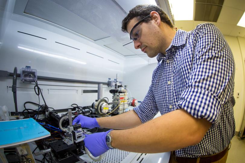 Stanford and SLAC postdoctoral researcher Sean Andrews with solution shearing instrument