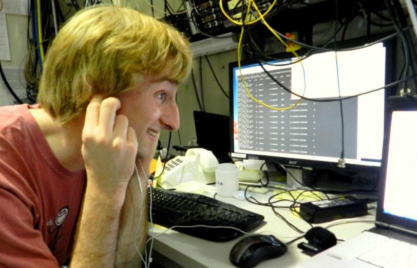 Image - Chris Pollock monitors an experiment at SLAC's Stanford Synchrotron Radiation Lightsource. (Courtesy of Chris Pollock)