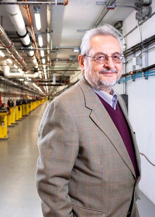 Image - Claudio Pellegrini stands in the Linac Coherent Light Source Beam Transport Hall. The accelerated electron beam passes through here to the Undulator Hall, where electron bunches generate X-rays. (Michelle McCarron)