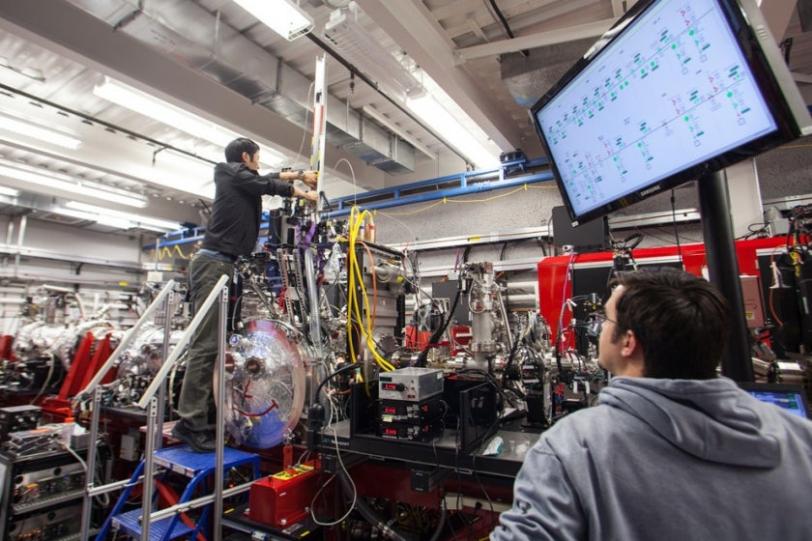 Image - Researchers Dingjie Wang and Garrett Nelson from Arizona State University insert a lipid cubic phase  injector containing tiny crystals of G protein-coupled receptors into the sample chamber during an experiment at SLAC's LCLS.