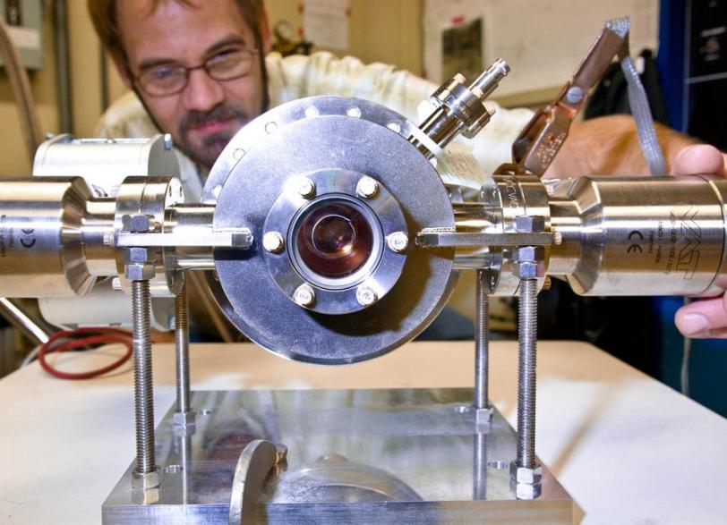 Photo - SLAC's Axel Brachmann examines a damaged LCLS...