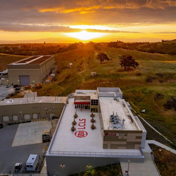 SLAC’s Linac Coherent Light Source (LCLS) Near Experimental Hall building at sunrise with Stanford University Hoover Tower in the background.