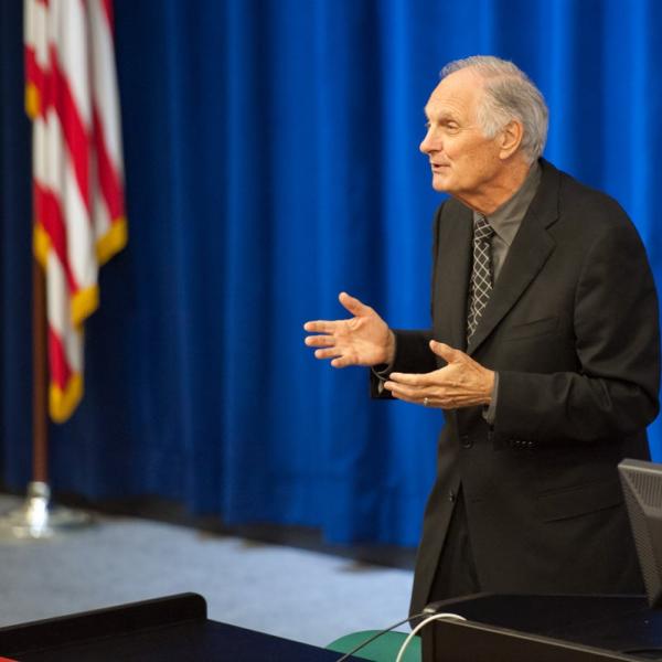 Photo - Alan Alda speaking in front of auditorium