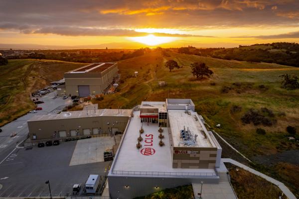 SLAC’s Linac Coherent Light Source (LCLS) Near Experimental Hall building at sunrise with Stanford University Hoover Tower in the background.