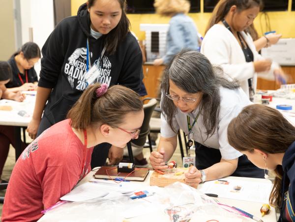 Lydia Young, SLAC’s chief engineer, helps students with an experiment at the lab’s SAGE-S summer camp.