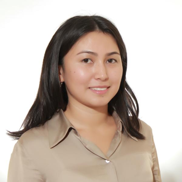 A portrait of a woman wearing a tan shirt.